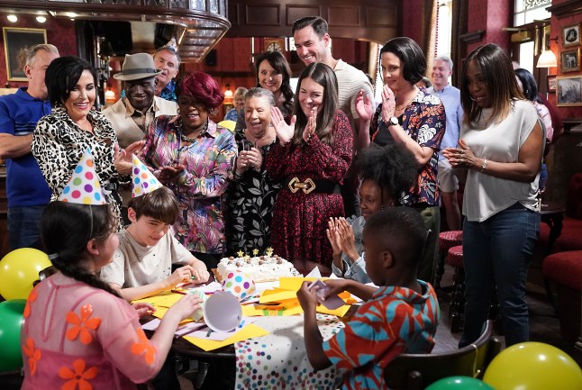 Kat, Alfie, Harvey, Kim, Patrick, Stacey, Mo, Honey, Eve, Zack and Denise gather around Hope, Arthur, Pearl and Micah in The Queen Vic in EastEnders