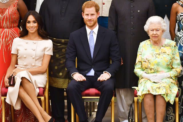 John Stillwell - WPA Pool/Getty Meghan Markle, Prince Harry and Queen Elizabeth at the Queen's Young Leaders Awards Ceremony at Buckingham Palace on June 26, 2018.