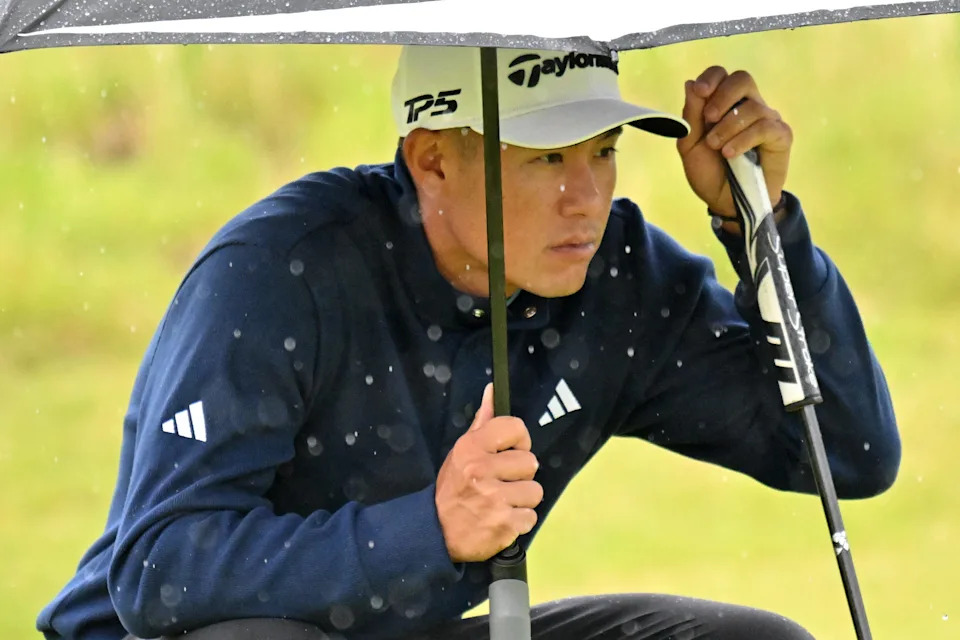 US golfer Collin Morikawa lines up a putt in the rain on the 7th green on the opening day of the 153rd Open Championship at Royal Portrush golf club in Northern Ireland on July 17, 2025. (Photo by ANDY BUCHANAN / AFP) / RESTRICTED TO EDITORIAL USE (Photo by ANDY BUCHANAN/AFP via Getty Images)
