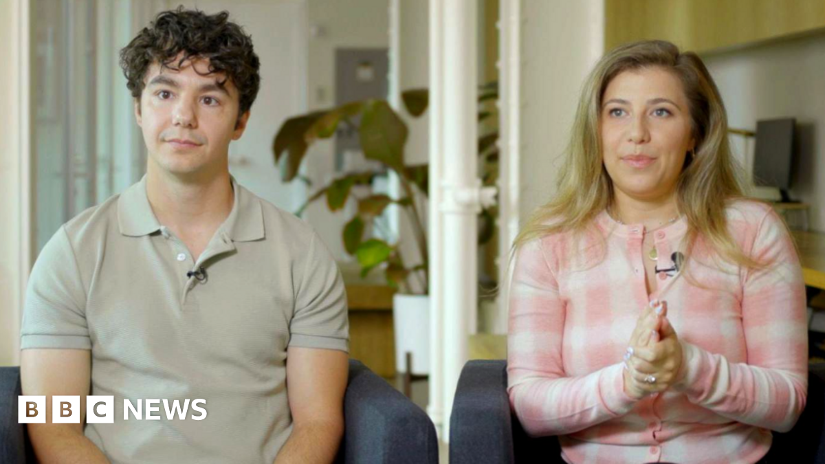 Paul Skye Lehrman and Linnea Sage, who claim their voices were stolen, sit in armchairs with neutral expressions.