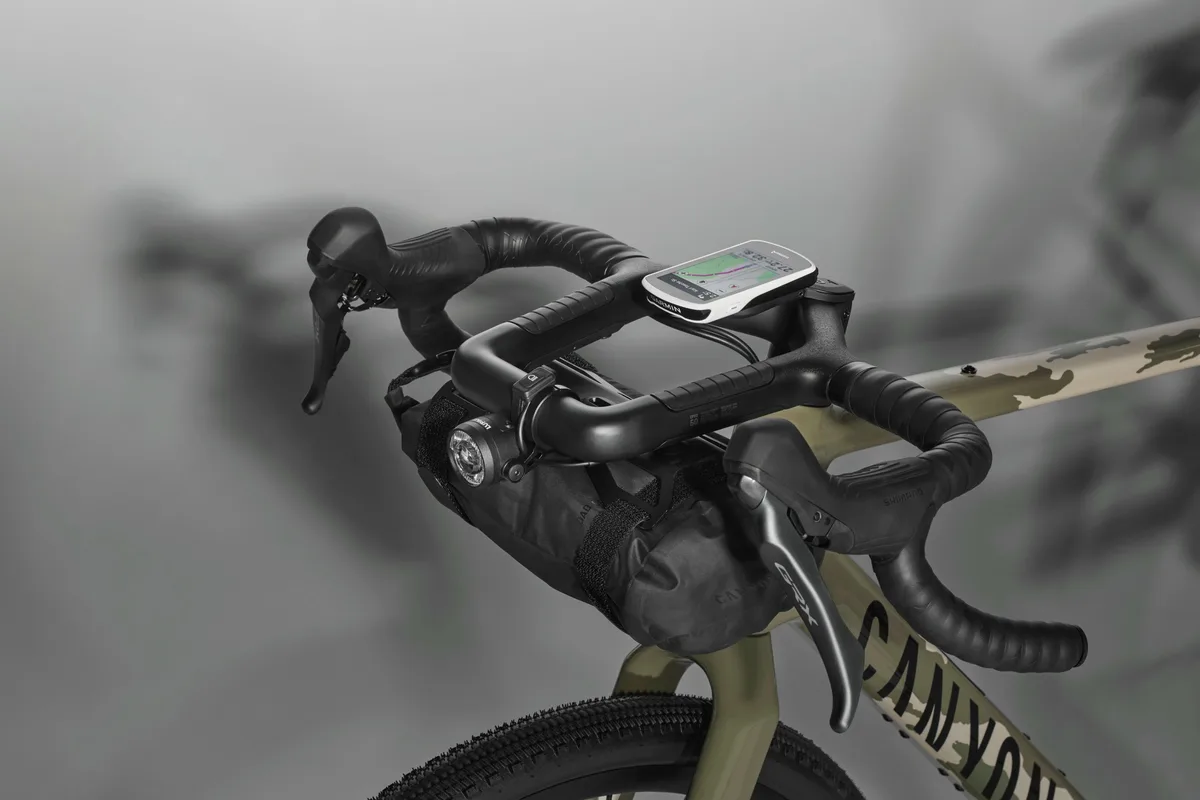 Full Monty handlebar on Canyon Grizl with computer and bag mounted to it.