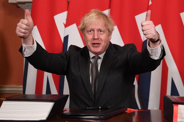 Boris Johnson gives a thumbs up gesture after signing the Brexit trade deal with the EU