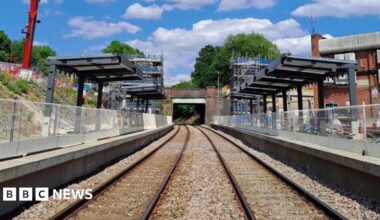 A railway track with platforms on both sides and the framework for coverings over both platforms