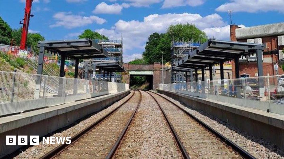 A railway track with platforms on both sides and the framework for coverings over both platforms