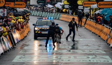 A protestor is tackled at the finish of stage 17 of the Tour de France