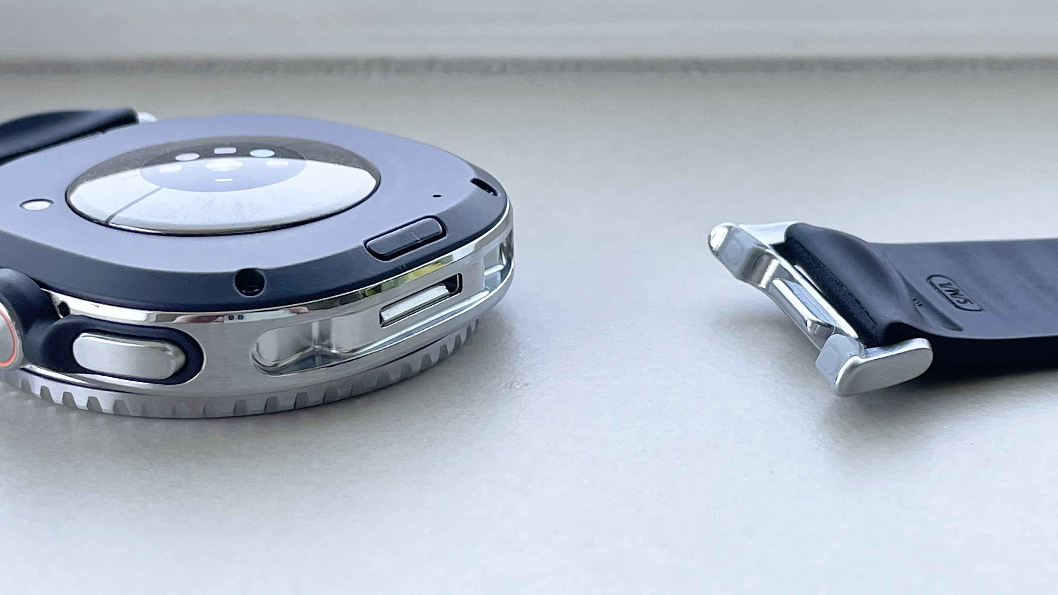 Close-up of the back of the Samsung Galaxy Watch 8 Classic showing the new Dynamic Lug strap system with one strap disconnected