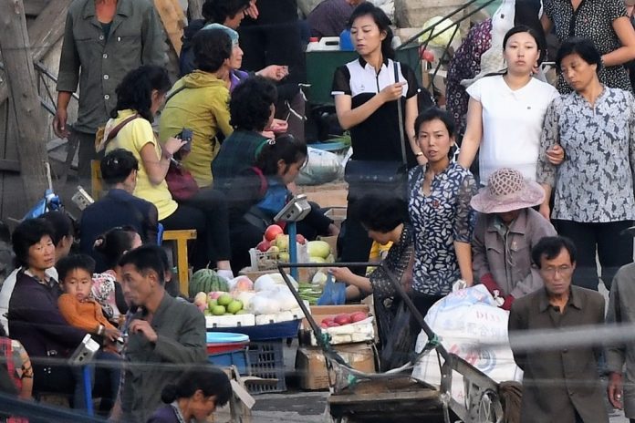 Street market in Hyesan, Yanggang Province rice sellers dollar rate, markets, market