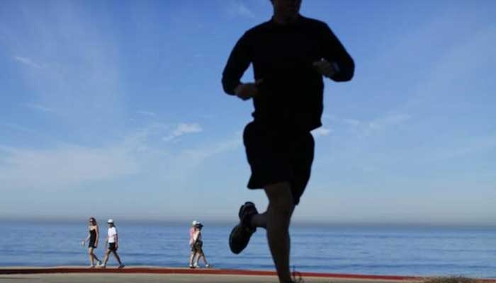 People walk and jog at Torrey Pines State Park in San Diego, California, November 14, 2012. — Reuters
