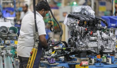 An employee works on an engine block on the assembly line at a manufacturing plant in Chennai, India. Filephoto: VCG