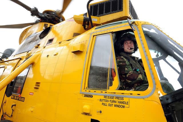 JOHN STILLWELL/AFP via Getty Prince William in a helicopter during training exercises in Wales on March 31, 2011
