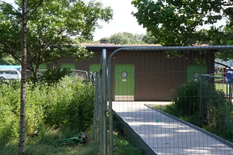 A low-rise building with five doors