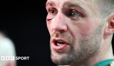 Josh Taylor celebrates winning by holding up the Scottish flag