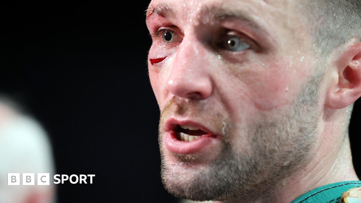 Josh Taylor celebrates winning by holding up the Scottish flag