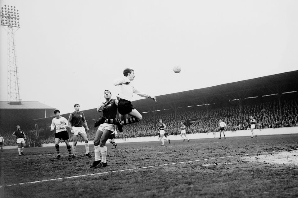 Willie Irvine leaps to head the ball while playing for Burnley