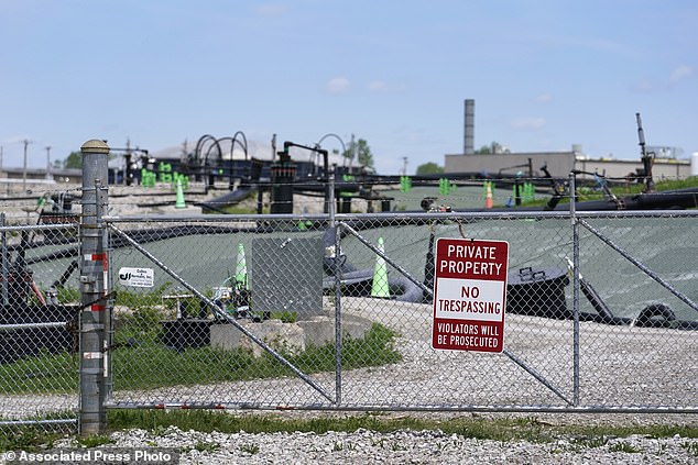 A no trespassing sign hangs on a fence around the West Lake Landfill Superfund site. St. Louis activists have been fighting for years to get government compensation for people with cancer and other serious illnesses potentially connected to Manhattan Project nuclear contamination