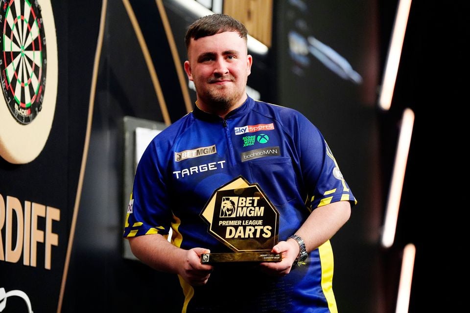 Luke Littler poses with the trophy after winning night seven of the BetMGM Premier League at Utilita Arena