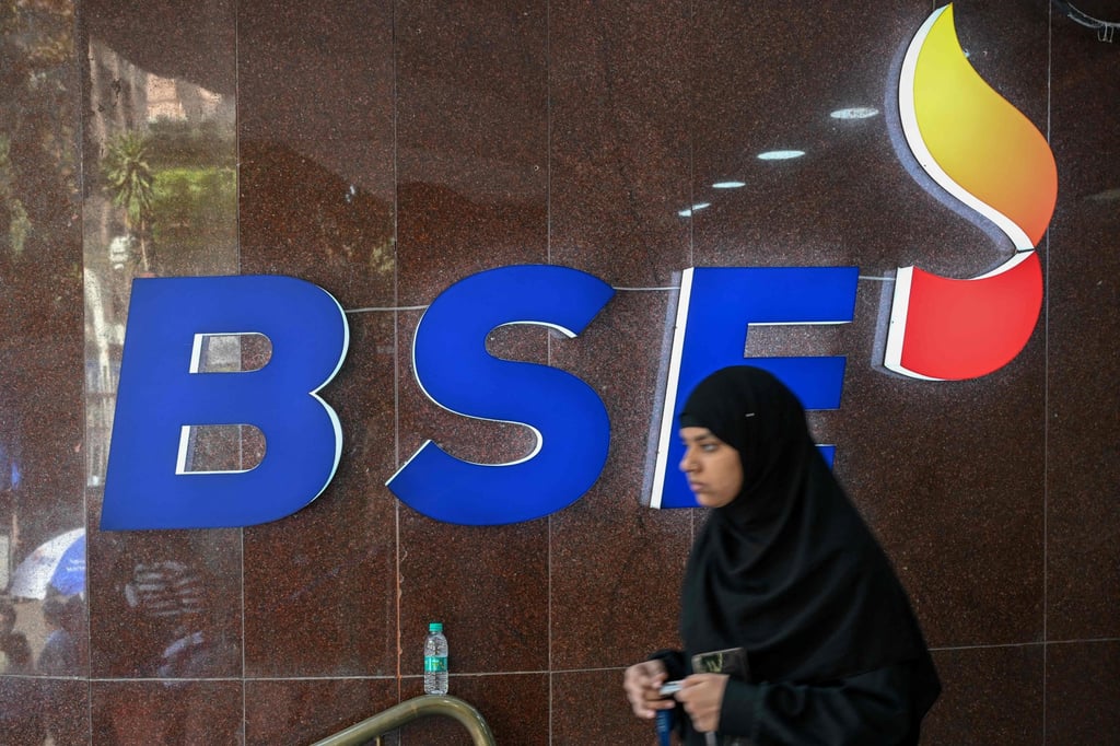 A woman walks past the logo of the Bombay Stock Exchange in Mumbai. Photo: AFP