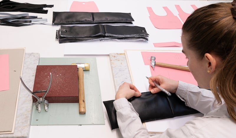 A Prada leather goods designer at work.