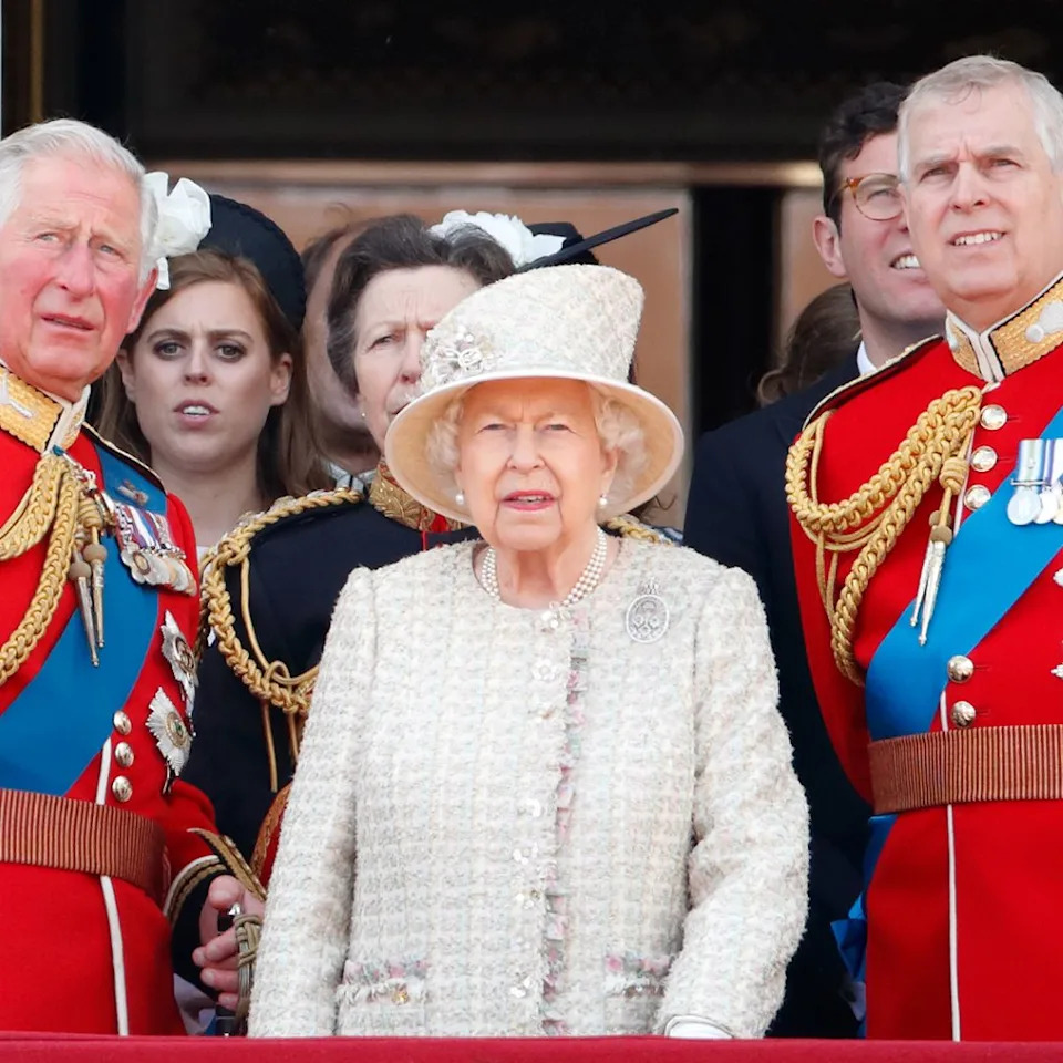  King Charles and Prince Andrew wear red military uniforms as they stand on the Buckingham Palace balcony with Queen Elizabeth II. 