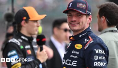 Max Verstappen smiles after taking pole for the British Grand Prix as Oscar Piastri was interviewed in the background