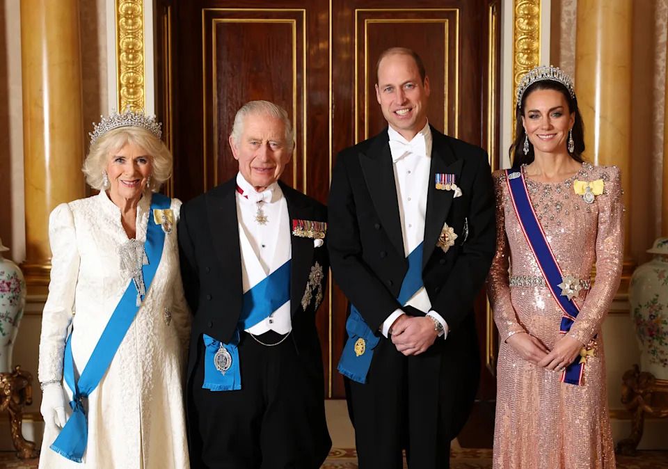 Queen Camilla, King Charles III, Prince William, Prince of Wales and Catherine, Princess of Wales pose for a photograph ahead of The Diplomatic Reception in the 1844 Room at Buckingham Palace on December 05, 2023 in London, England. 