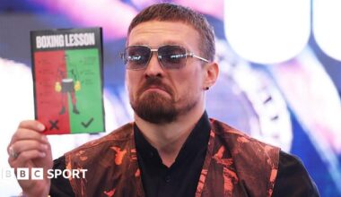 Oleksandr Usyk reading a 'boxing lesson' pamphlet