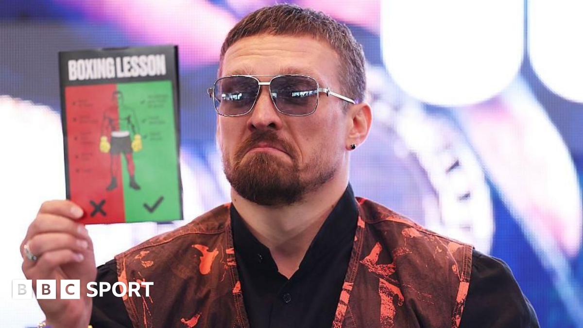 Oleksandr Usyk reading a 'boxing lesson' pamphlet