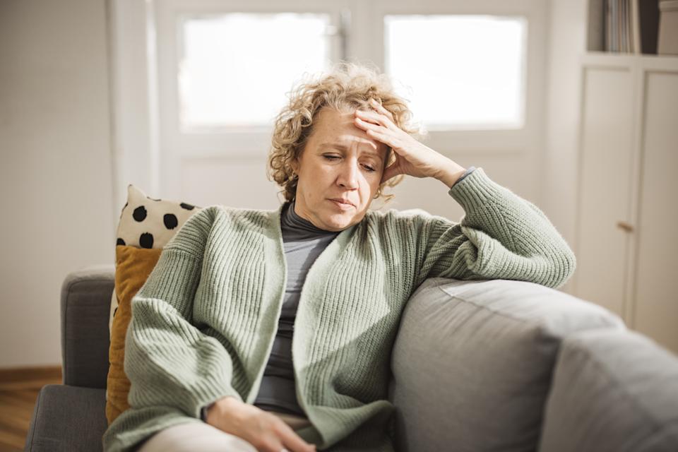 Portrait of mature woman at home. She is stressed and unhappy about something. (Getty Images)