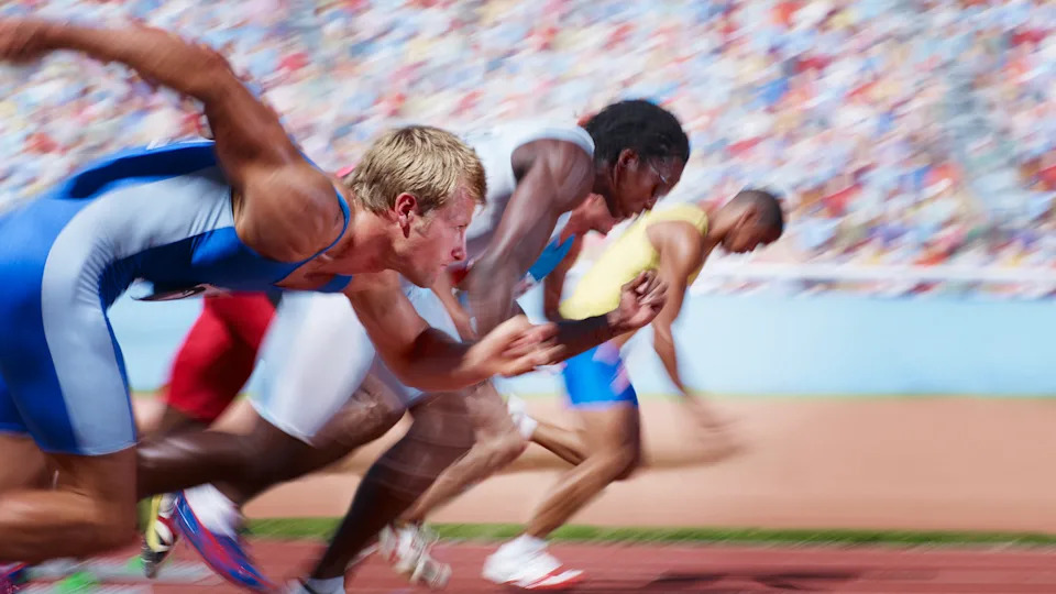  Runners jumping off the starting line for a race. 