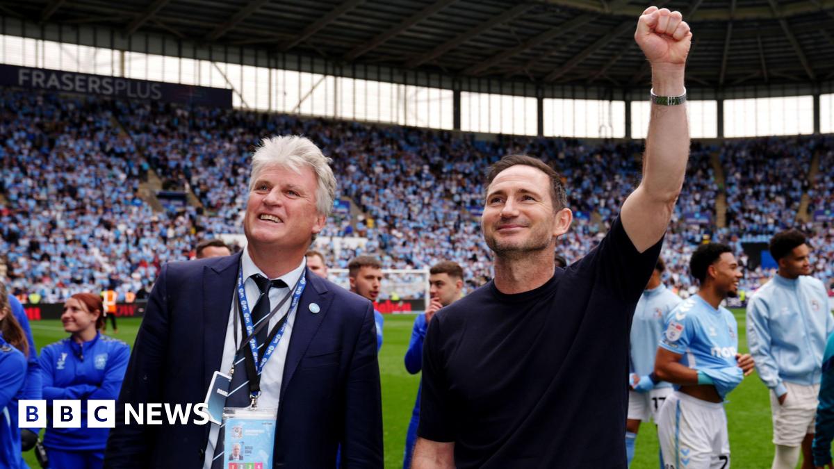 Coventry City owner Doug King pictured with manager Frank Lampard at the Coventry Building Society Arena celebrating with fans. They are both smiling and Frank Lampard has his left first raised in celebration.