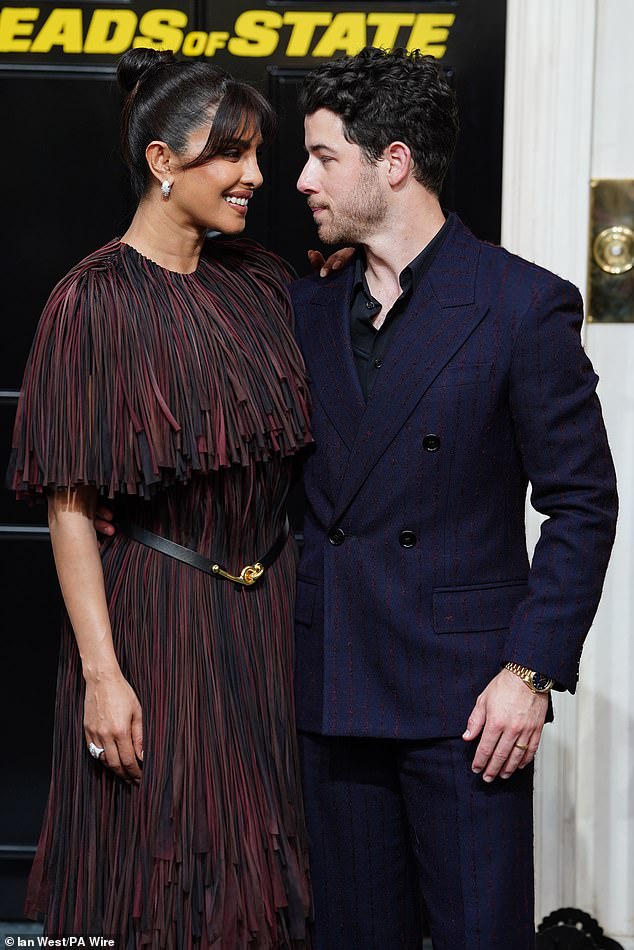 The Jonas singer cut a dapper figure in a navy suit as he lovingly gazed into his wife's eyes