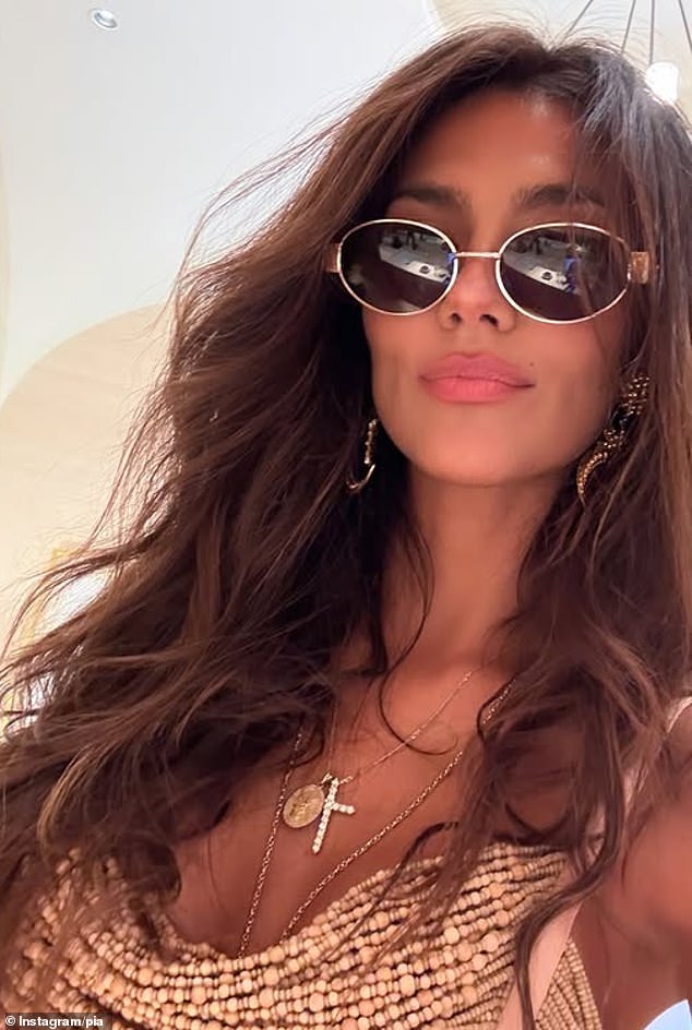 She wore Céline sunglasses and completed the look with gold earrings