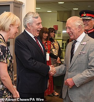 Charles appeared in high spirits as he greeted Gordon Brown with a firm handshake in Scotland today