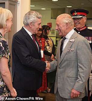 Charles appeared in high spirits as he greeted Gordon Brown with a firm handshake in Scotland today