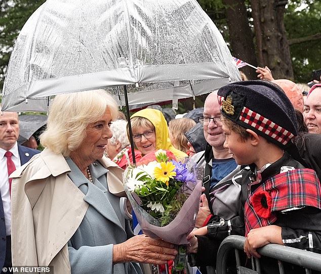 Camilla gladly accepted a bunch of brightly coloured flowers from a young boy waiting in the crowd
