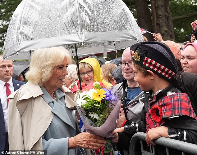 Camilla worked her way through the crowds, and received a special gift from one young boy waiting for her