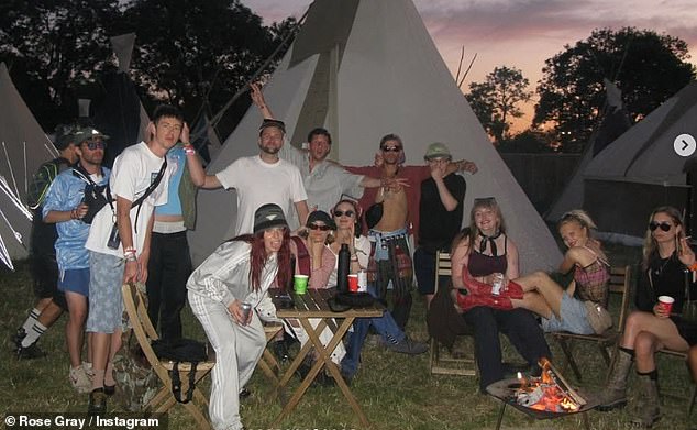 The group posed together alongside tipis while drinking and smoking