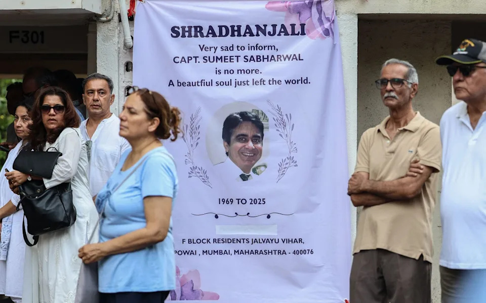 Mourners gather at a memorial banner to Captain Sumeet Sabharwal in Mumbai last month