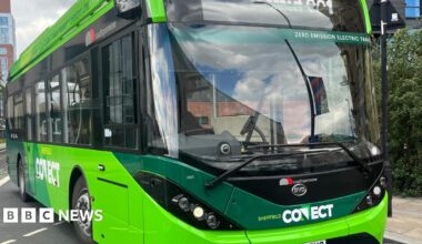 A green bus, seen from an angle at the front. The bus says Sheffield Connect on the front and above the window on the front it says Zero Emission Electric Travel.