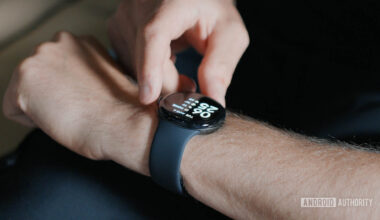A man pressed the digital crown of his Google Pixel Watch 3.