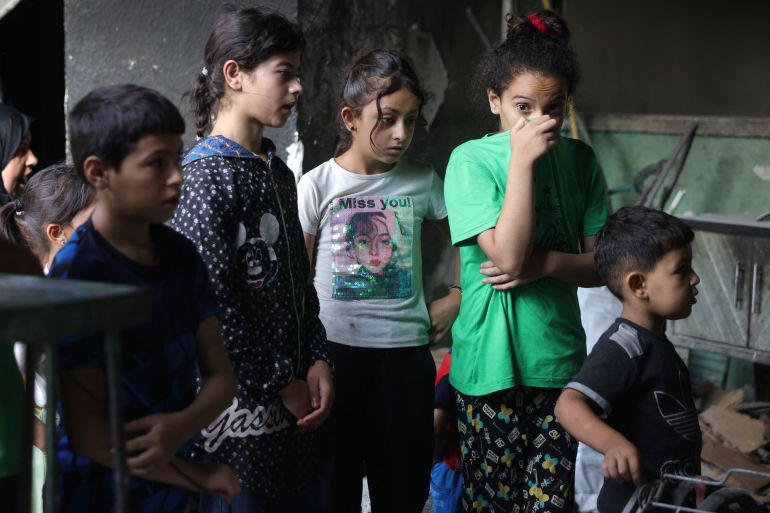 Palestinian children at the site of an Israeli strike on the Halima Saadiya school in Jabalia in the northern Gaza Strip.