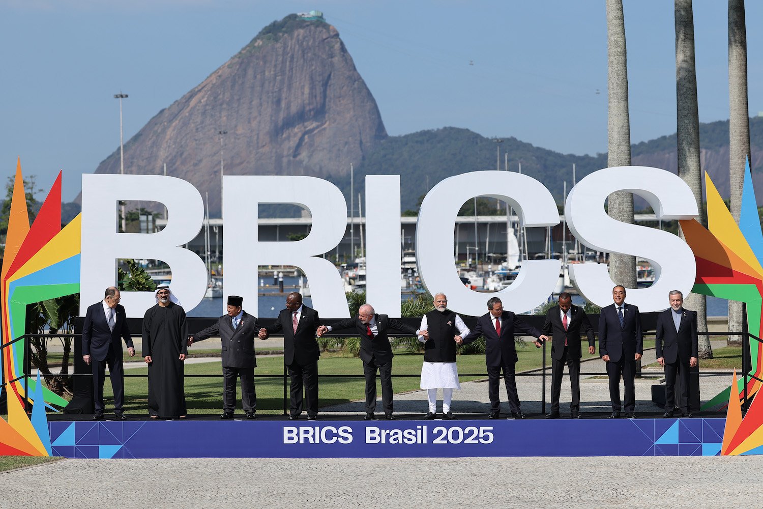Leaders pose in front of a big sign that reads: "BRICS."