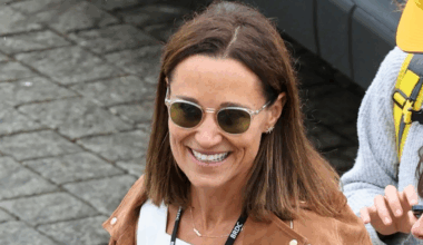 Pippa Middleton wearing a suede jacket and white dress walking outside at British Grand Prix