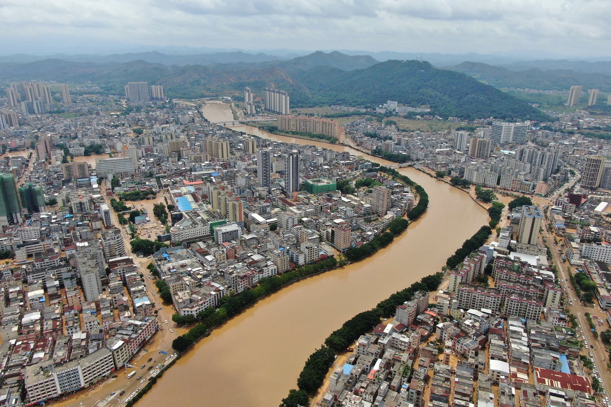 China on high alert for floods as record rain triggers landslides and building collapse