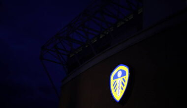 Leeds United's badge lit up on Elland Road at night