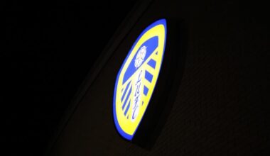 Leeds United's badge lit up at night at Elland Road