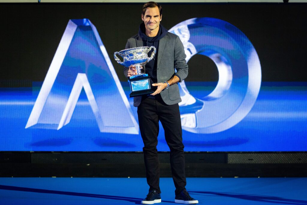 Roger Federer waves with the Australian Open trophy
