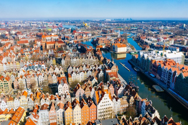 An aerial view of Gdansk's historic city centre, colourful buildings, and river.