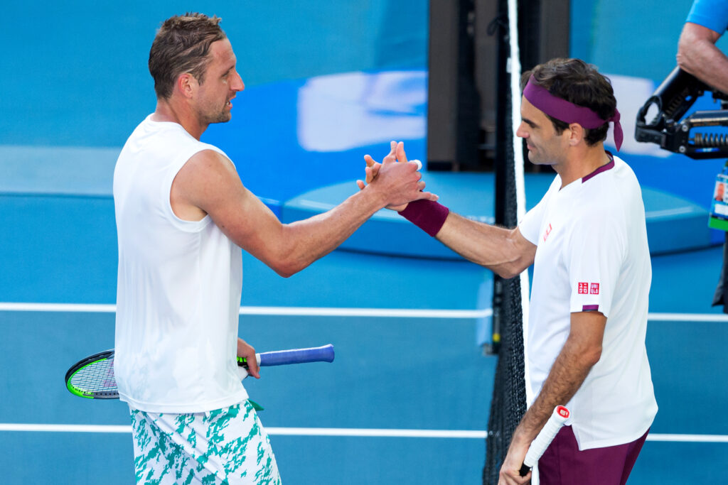 Tennys Sandgren and Roger Federer shake hands