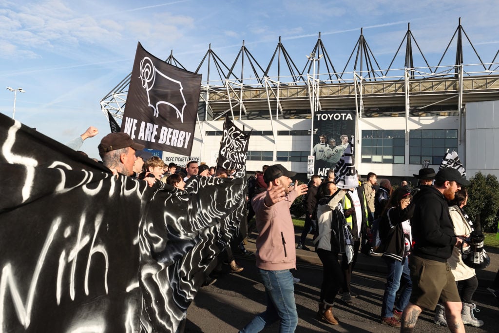 Derby County fans protest against chairman Mel Morris before the Sky Bet Championship match between Derby County and Birmingham City at Pride Park Stadium on January 30, 2022 in Derby, England.